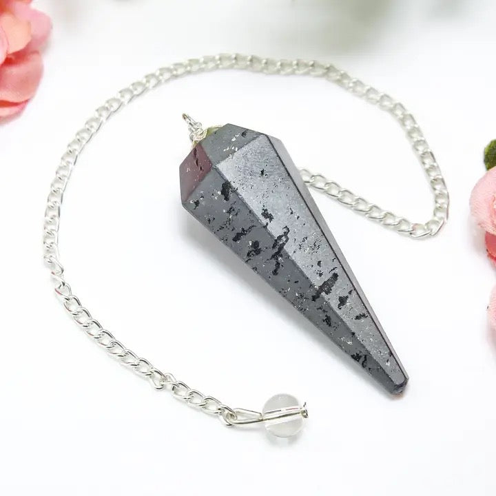 Crystal pendulum with chain on a white background