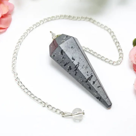 Crystal pendulum with chain on a white background