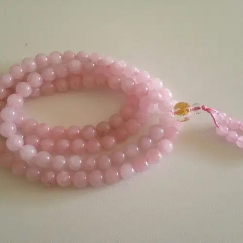 Pink beaded bracelet on a light background
