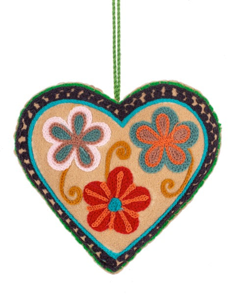 Decorative heart-shaped hanging with floral designs on a white background