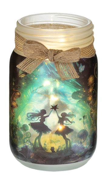 Mason jar with fairy silhouette design and glowing interior on a white background