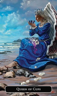 Card featuring a person in a blue dress with a crown, sitting on a beach holding a cup, labeled 'Queen of Cups'.