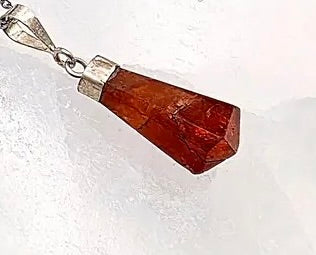 Pendant Orange Garnet Point on a crystal background