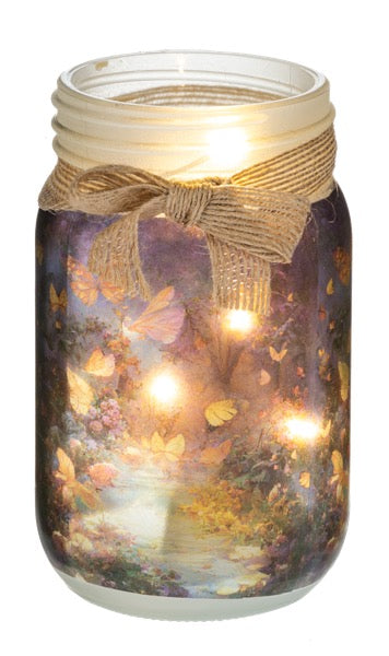 Decorative jar with a scenic design and string lights on a white background
