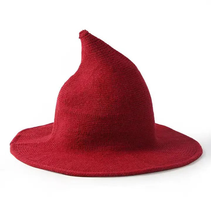 A red pointed witch hat made of textured knit fabric, shown on a plain white background.
