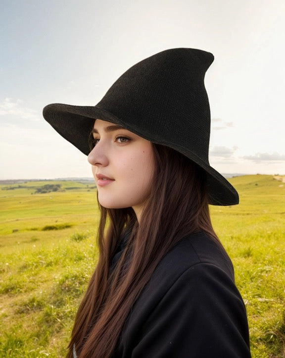 Woman wearing a black hat in a field