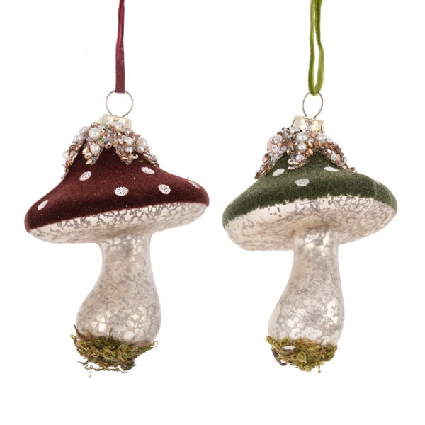 Two decorative mushroom ornaments with speckled caps on a white background