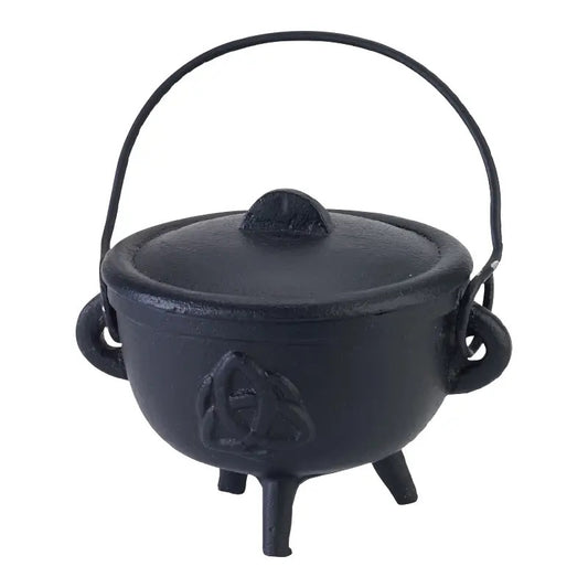 Black cast iron cauldron with lid on a white background