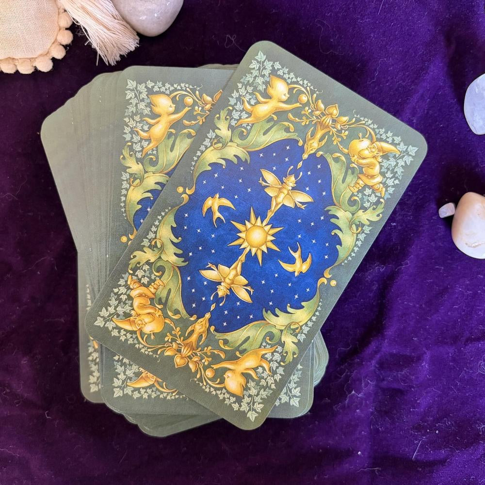 Set of tarot cards with celestial design on a purple fabric background