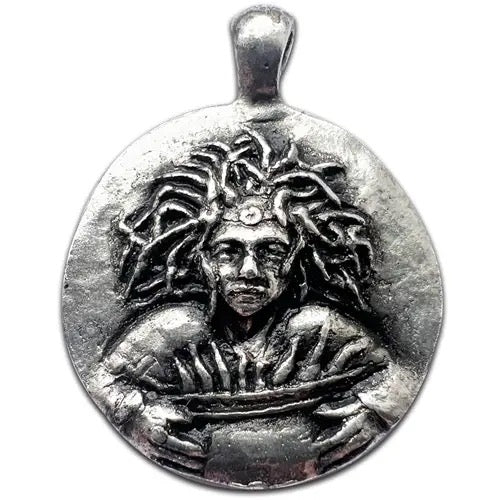 A circular silver pendant featuring an embossed relief of a figure with flowing hair, shown on a plain white background.