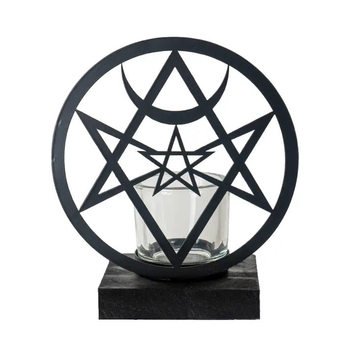 Black star-shaped candle holder with a glass candle inside on a white background