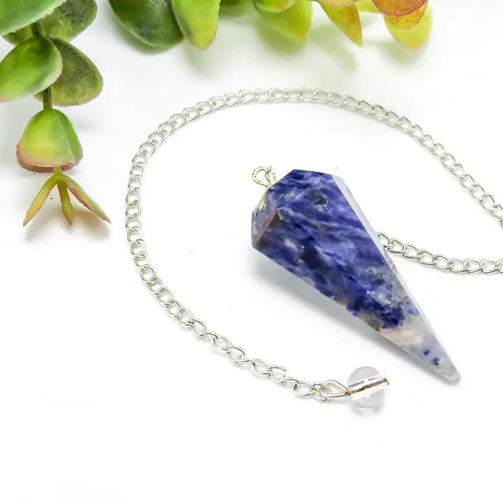 Pendulum Sodalite on a white table