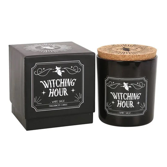 Black candle labeled 'Witching Hour' with a cork lid next to its packaging on a white background