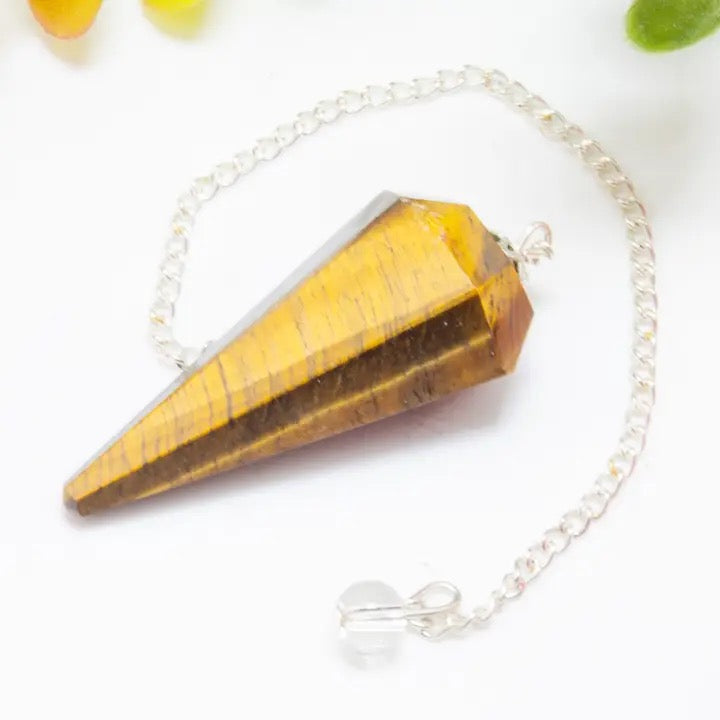 Pendulum Tiger Eye on a white table