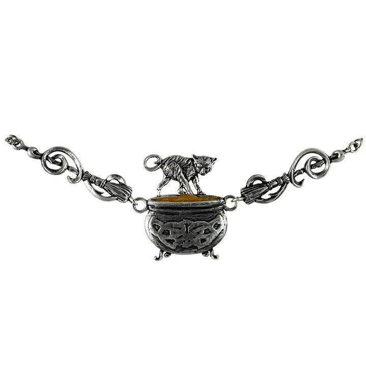 A silver-toned pendant necklace featuring a cauldron with a small dog standing on top, flanked by decorative chain links and tassels, shown against a plain white background.