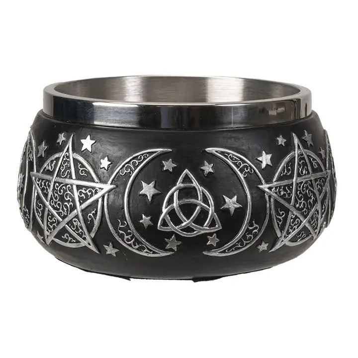 Black bowl with silver star, moon, and triangle designs on a white background