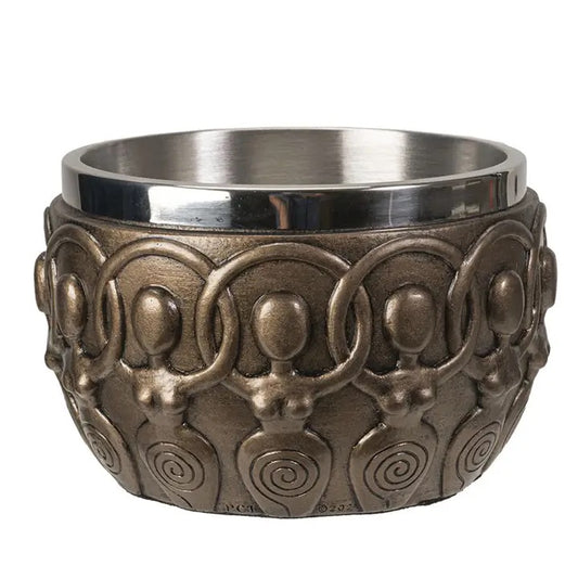 Decorative bronze looking cup with intricate patterns on a white background