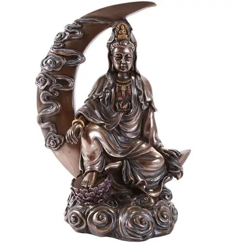 Statue of a seated figure with a crescent moon and floral designs on a white background