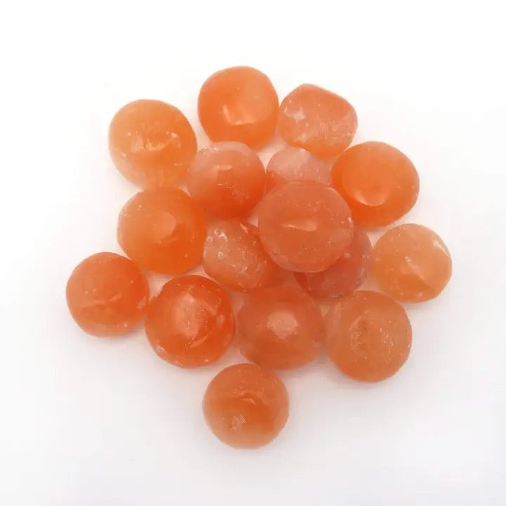 Selenite Orange Tumbled on a white background