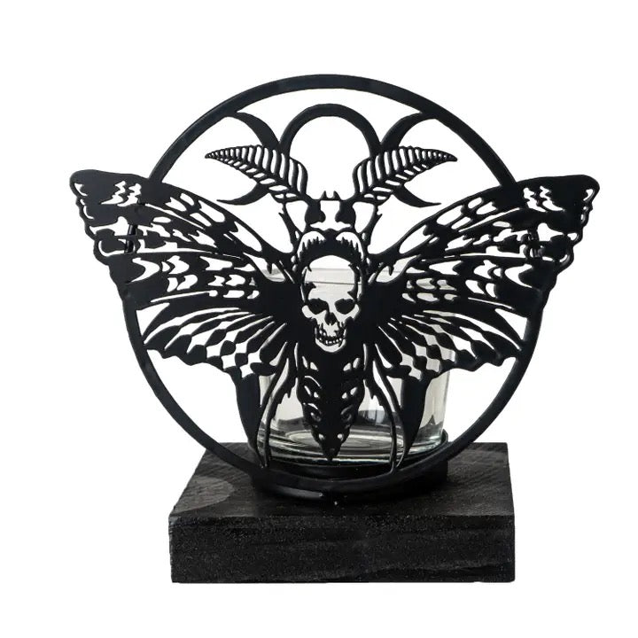 Decorative item with butterfly and skull design on a black base