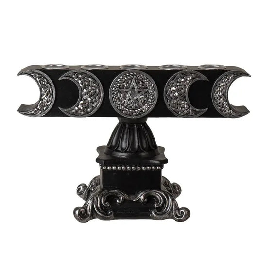 Decorative black and silver candle holder with pentacle design on a white background