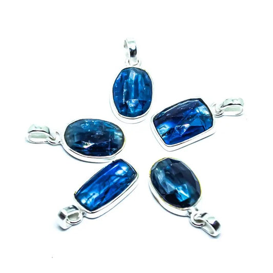 Set of blue gemstone pendants with silver settings on a white background