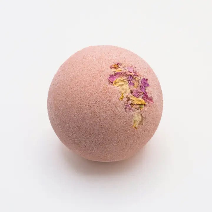 Pink bath bomb with floral design on a white background