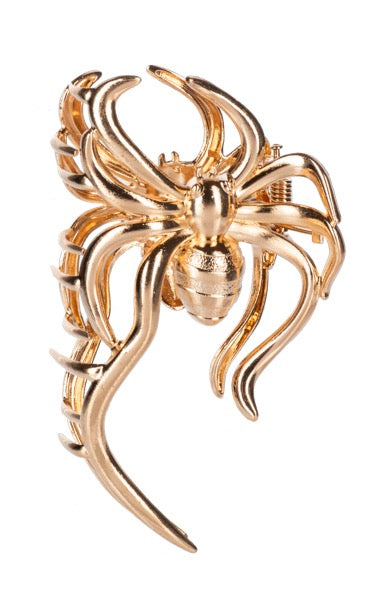 Gold spider-shaped Hair piece on a white background