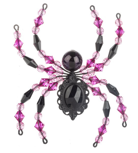 Decorative spider ornament with pink and black beads on a white background