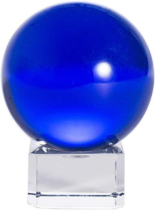 Blue glass sphere on a clear base against a white background