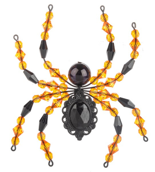 Decorative spider with orange and black beads on a white background