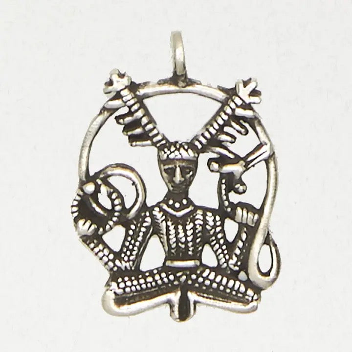 Silver pendant with intricate design on a white background