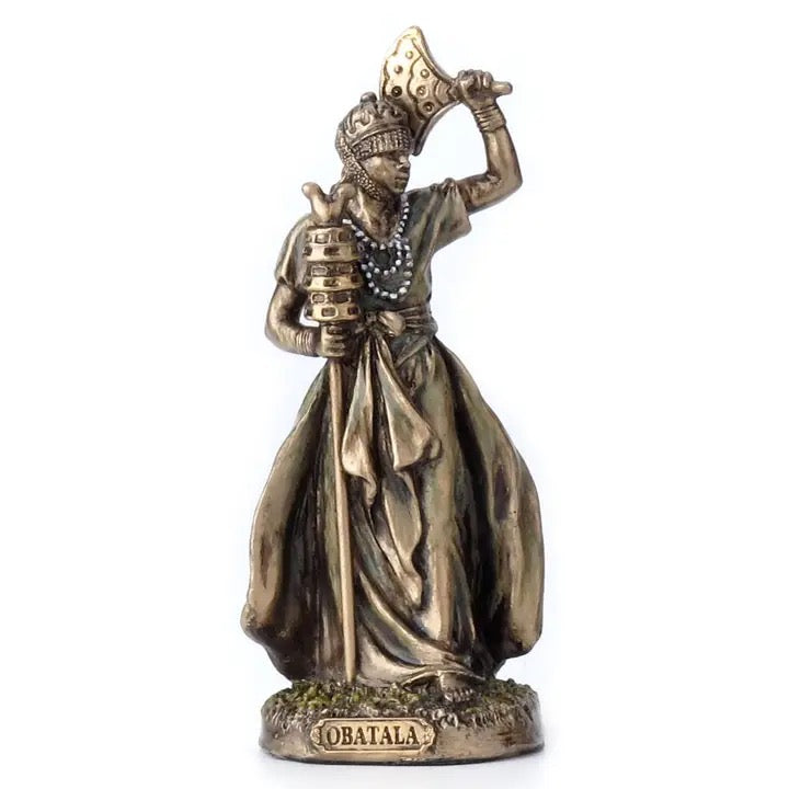 Bronze statue of a figure holding an axe on a white background