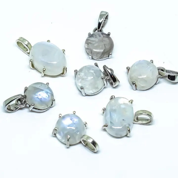 Set of silver pendants with moonstone stones on a white background