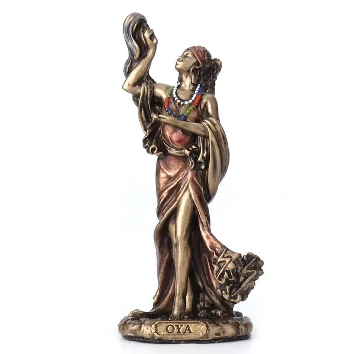 Bronze figurine of a woman with 'Oya' inscribed on a white background