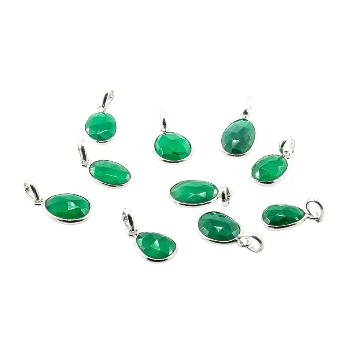 Set of green stone pendants on a white background