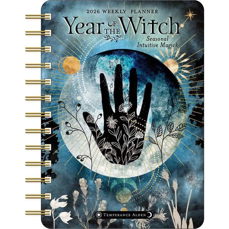 Planner with 'Year of the Witch' design featuring a hand and moon illustration on a blue background.