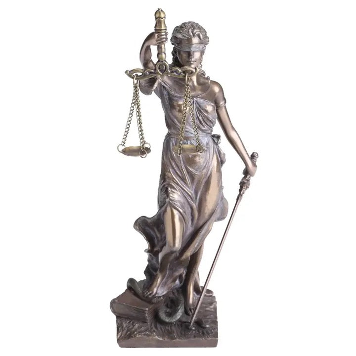 Statue of a woman holding scales and a sword on a white background