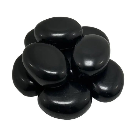 Black stones stacked on a white background