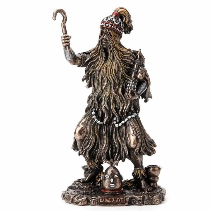 Statue of a figure with long hair and a hat, holding a staff, on a white background.