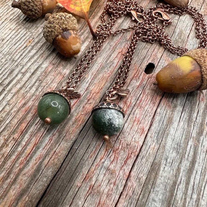 Necklace with acorn pendants on a wooden surface