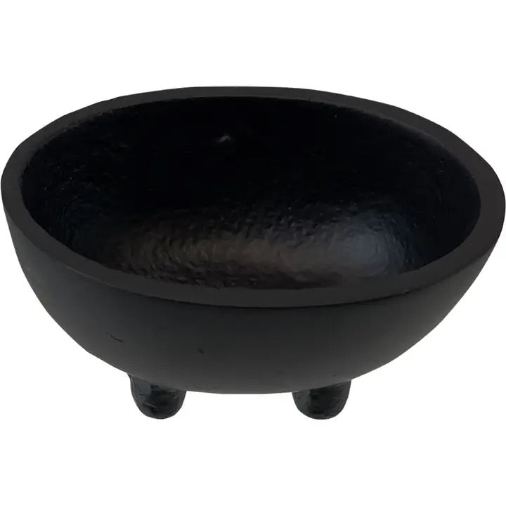Black ceramic bowl with three legs on a white background