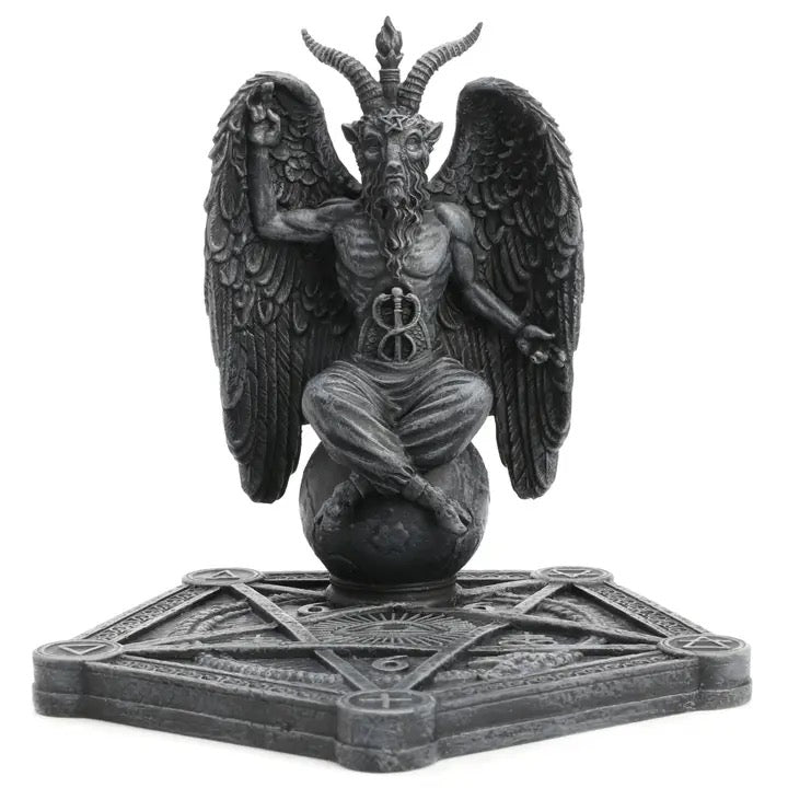 Statue of Baphomet a winged being with horns on a pentagram base against a white background
