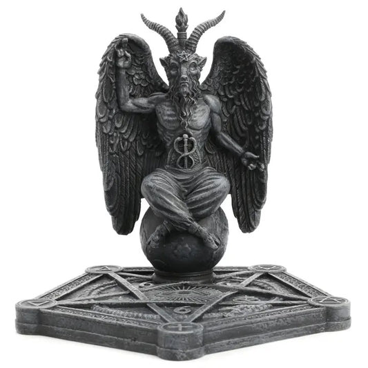 Statue of Baphomet a winged being with horns on a pentagram base against a white background