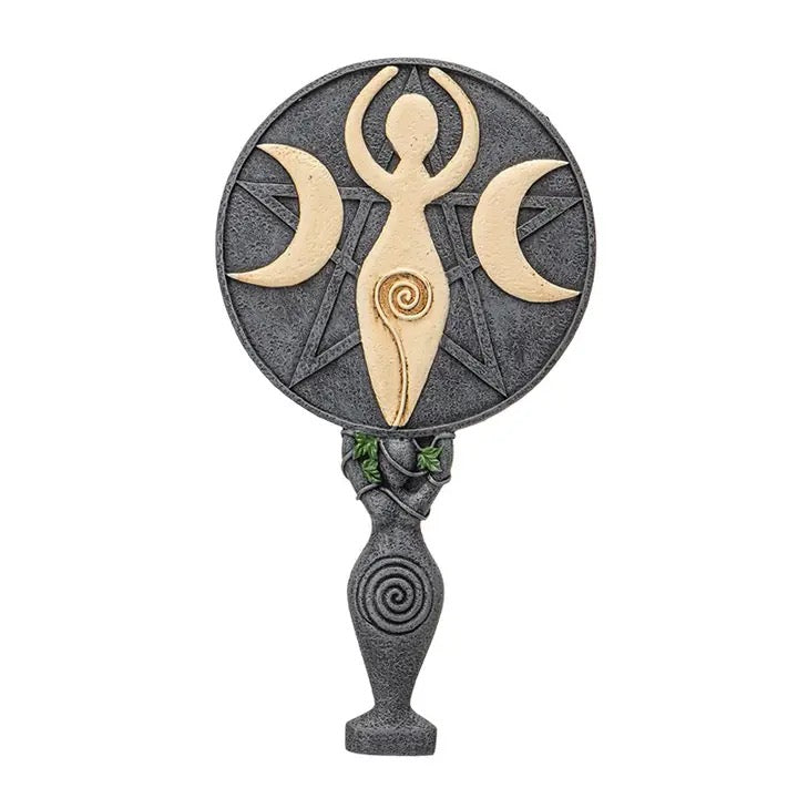 Decorative hand mirror with a woman's figure and crescent moons on a white background