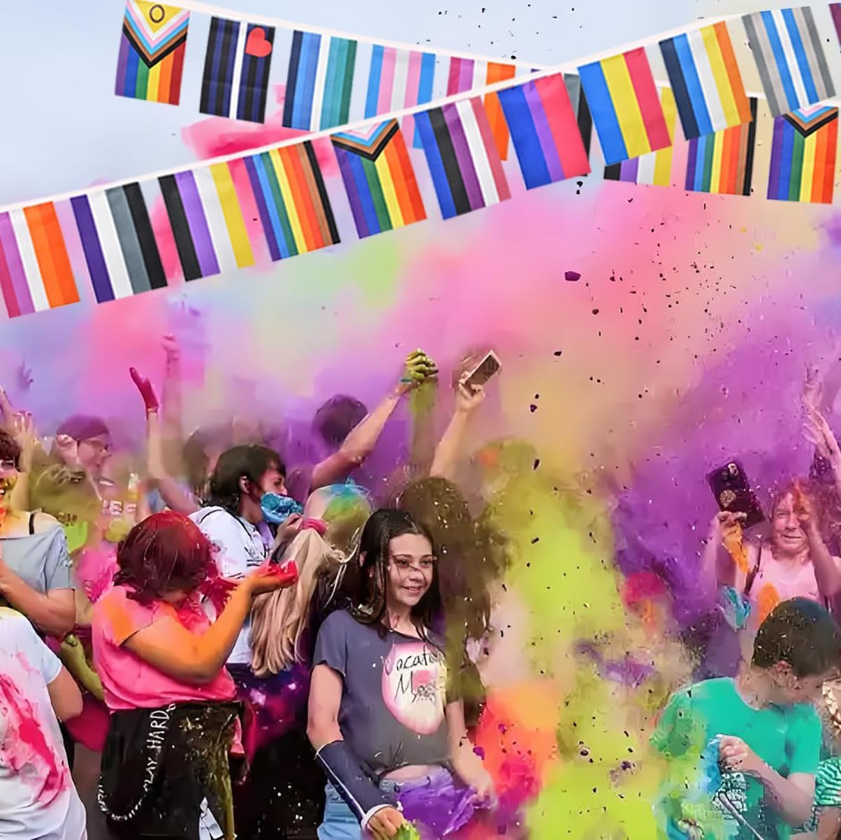 People celebrating with colorful powder and rainbow flags in the background
