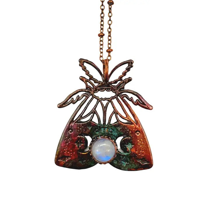 Pendant with moth design and central gemstone on a white background