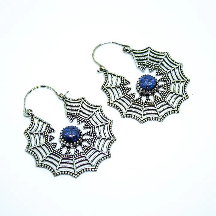Spider web earrings with blue gemstones on a white background