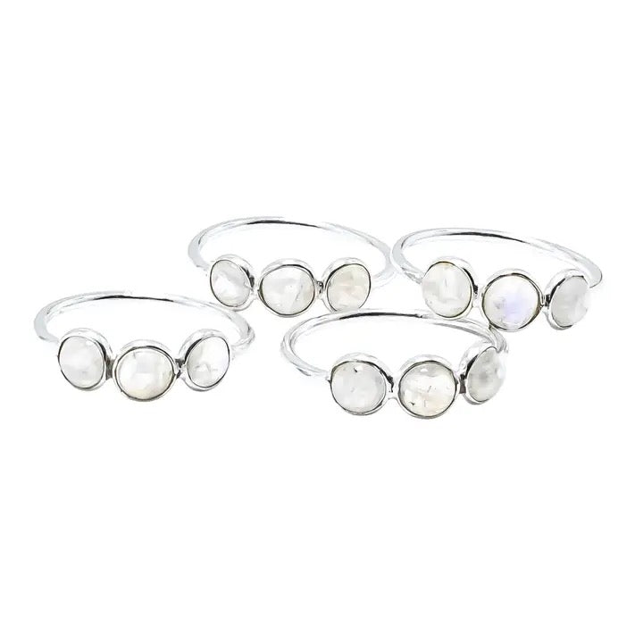 Set of silver bangles with moonstone stones on a white background