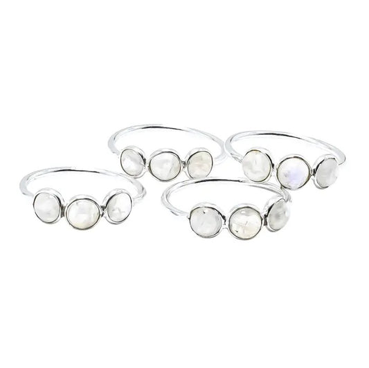 Set of silver bangles with moonstone stones on a white background